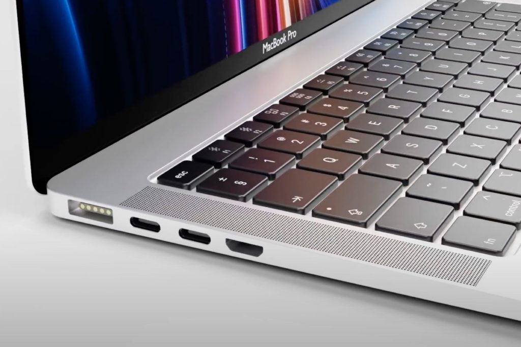 A silver laptop is open, showing a keyboard and a colorful screen. Ports for charging and connectivity are visible on the side.